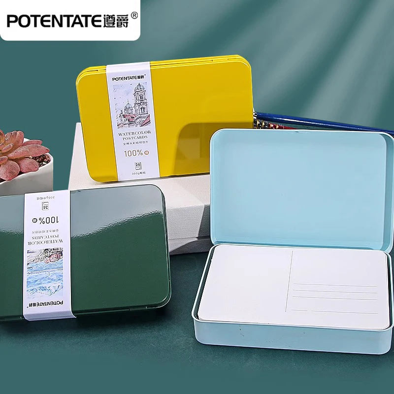 A set of Potentate watercolor paper cards in yellow and light blue packaging displayed on a dark green surface.