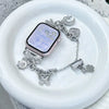 A silver diamond butterfly watch strap is displayed on a white plate.