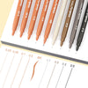 A collection of micro-pen fineliner pens in various shades and thicknesses, including orange, brown, and black.