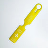 A bright yellow durable PVC luggage tag with a loop handle and text on the tag.