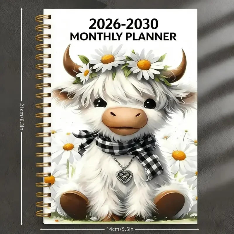A cute white calf with horns and a floral wreath sits on a monthly planner cover for 2026-2030.