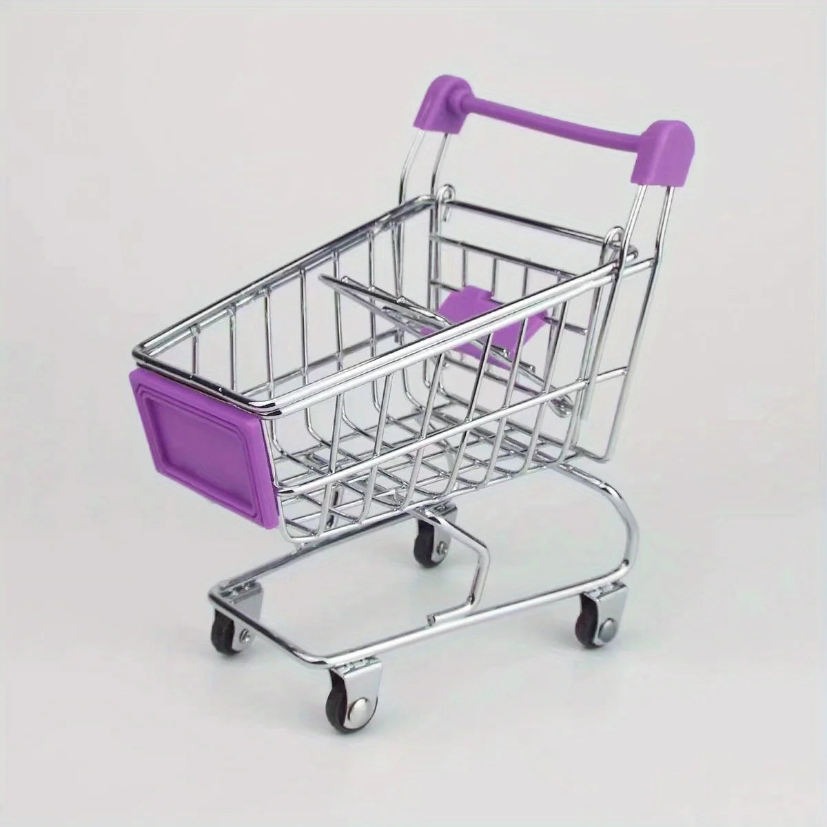 A silver mini shopping cart with purple accents and rolling wheels used as a desktop organizer.