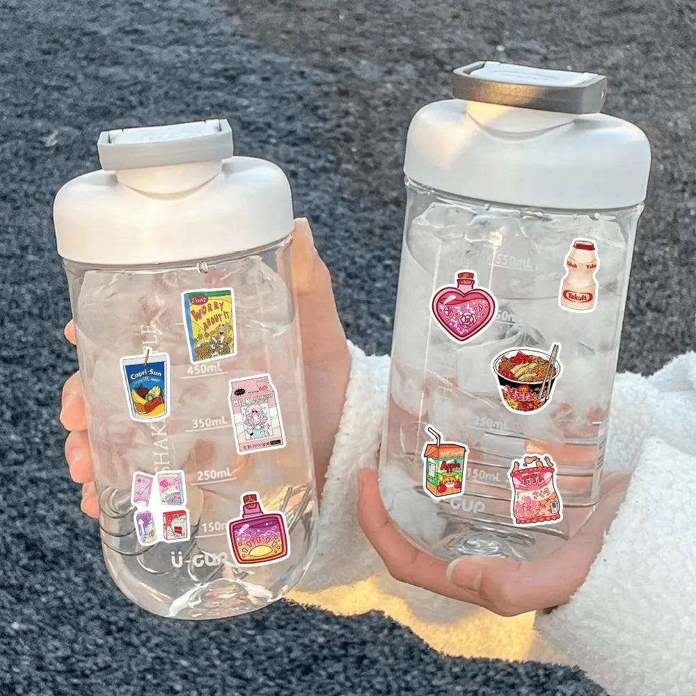 A hand holds a clear plastic bottle filled with water and various colorful cartoon stickers for journaling and decor.