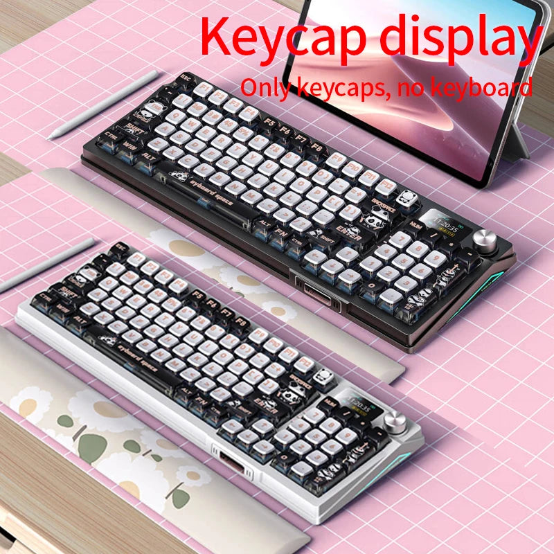 A close-up view of a PBT sublimated shark keycap keyboard displayed on a pink surface next to a tablet.