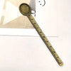 Vintage brass straight ruler with a round measuring scoop and minimalist design