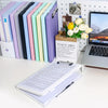 A set of colorful A4 document and photo storage file boxes displayed next to a laptop and a bouquet of white roses.