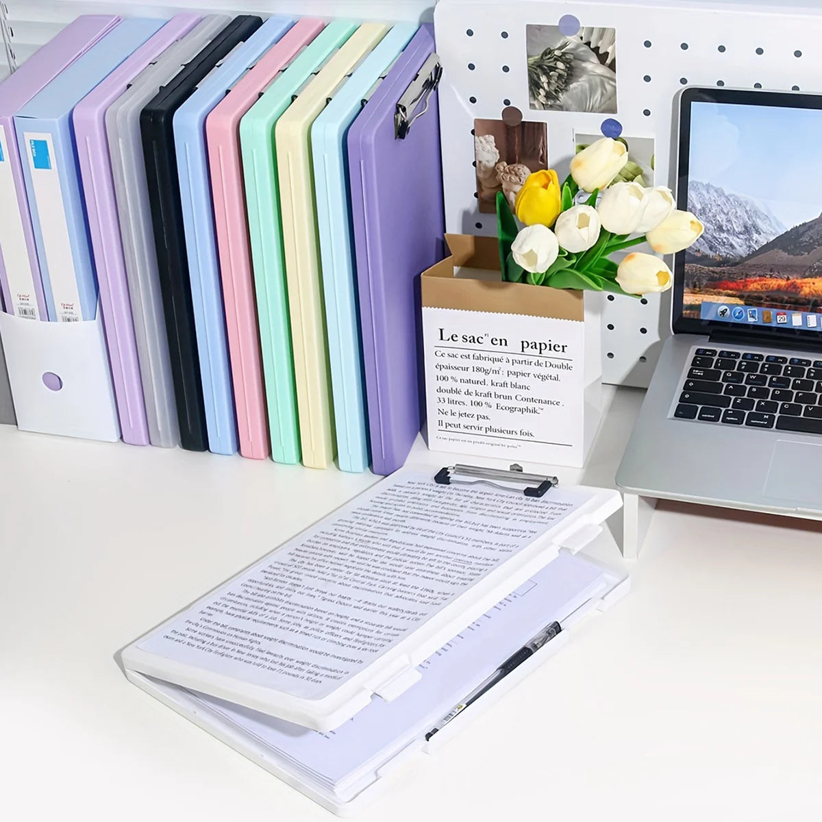 A set of colorful A4 document and photo storage file boxes displayed next to a laptop and a bouquet of white roses.