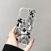 Clear acrylic phone case featuring Chrome Hearts motifs including crosses and floral designs