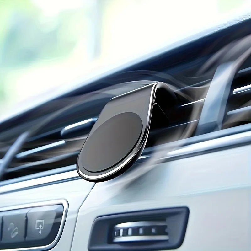 A close-up of a magnetic car air vent phone mount installed in a vehicle's interior