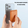 A hand holds a gray smartphone and an orange leather wallet with a stand case.