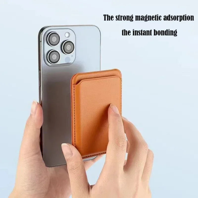 A hand holds a gray smartphone and an orange leather wallet with a stand case.