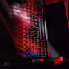 Close-up of a mechanical keyboard with carbon fiber keycaps and side engraved backlit features.