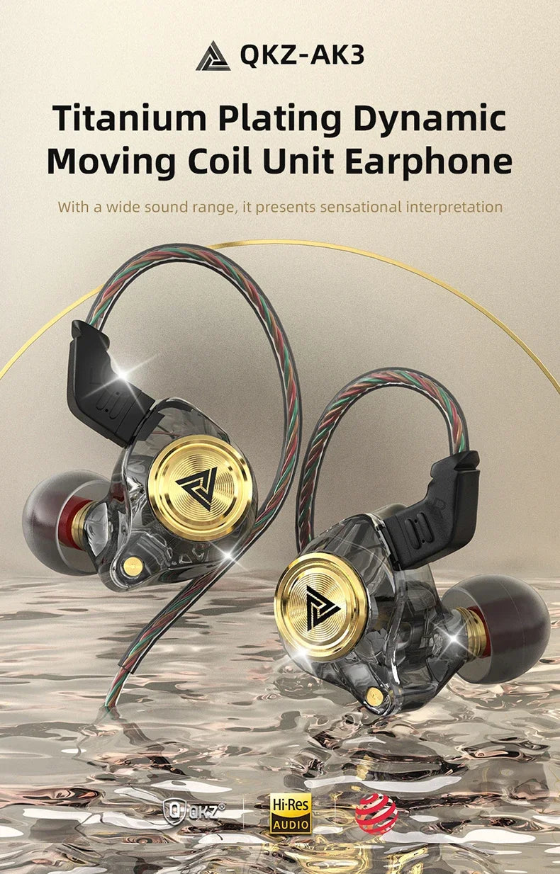 A pair of titanium plating dynamic moving coil earphones with gold accents shown against a reflective surface.