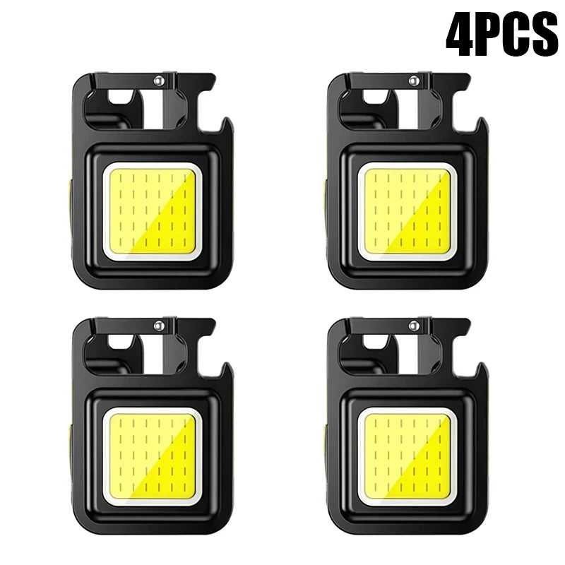 Four compact COB keychain flashlights with magnetic bases and rechargeable batteries shown in black.