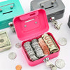 A pink steel cash box with a key lock and removable tray is shown alongside various coins and keys.