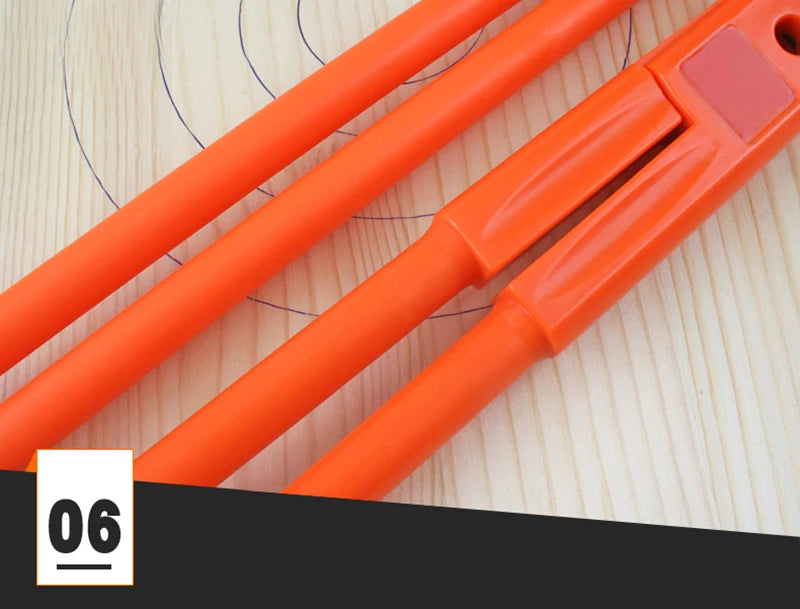 Orange adjustable woodworking marking compass with pencil holder resting on a light wooden surface.