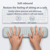 Hands resting on a light blue ergonomic wrist rest pad demonstrating soft rebound and support.
