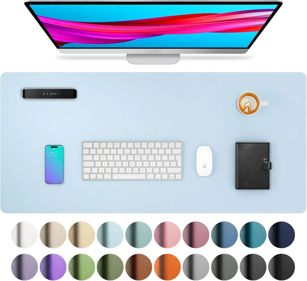 A large PU leather desk mat is shown with a computer monitor, keyboard, mouse, and smartphone on a light blue surface.