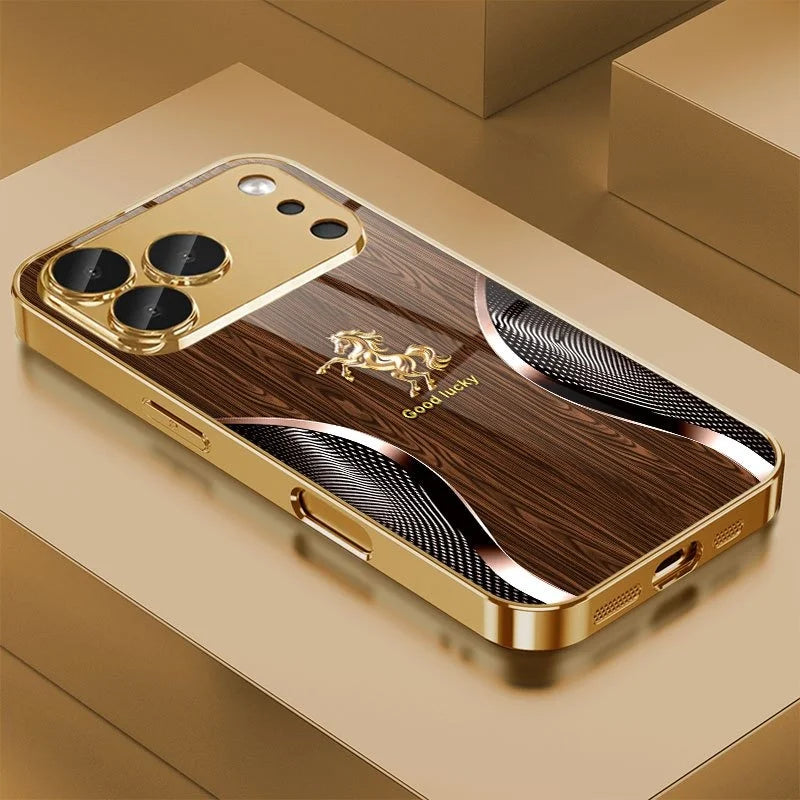 A golden phone case with wood grain texture and a horse design resting on a light brown surface.