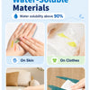 A set of silky crayon materials demonstrating water solubility on skin, clothes, furniture, and floor.