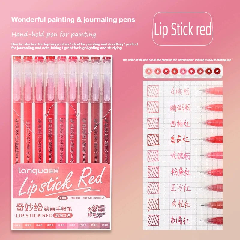 A set of red lip stick pens and journaling pens displayed on a pink background.