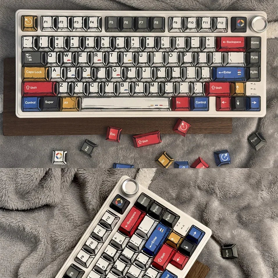 A close-up view of a white mechanical keyboard with colorful comic style keycaps and various keycaps scattered around it on a