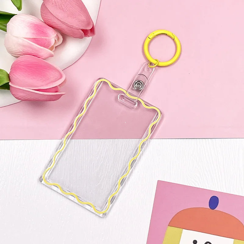 Clear acrylic card holder with a yellow keyring and pink tulips on a light pink background.