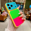 A hand holds a colorful block acrylic phone case with multiple colored sections and decorative elements.