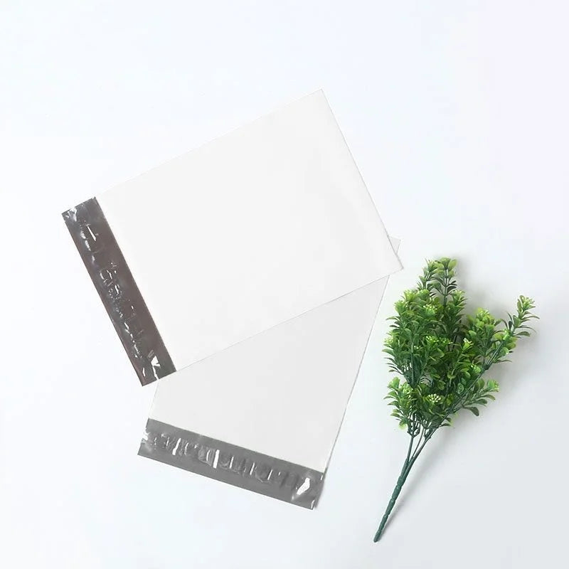 A stack of clear waterproof packaging bags for shipping on a white surface.