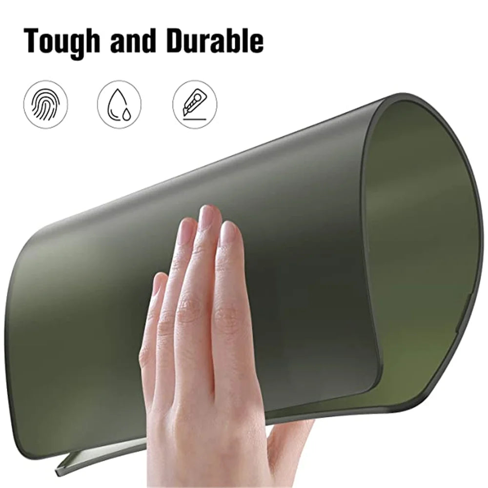 A hand is touching a dark green, ultra-thin hard shell laptop case for a MacBook Pro or Air.