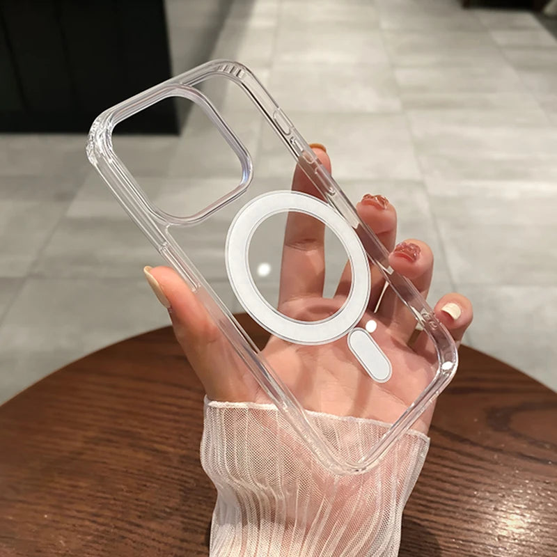 A hand holds a clear magnetic transparent phone case with a circular cutout and a small rectangular cutout.