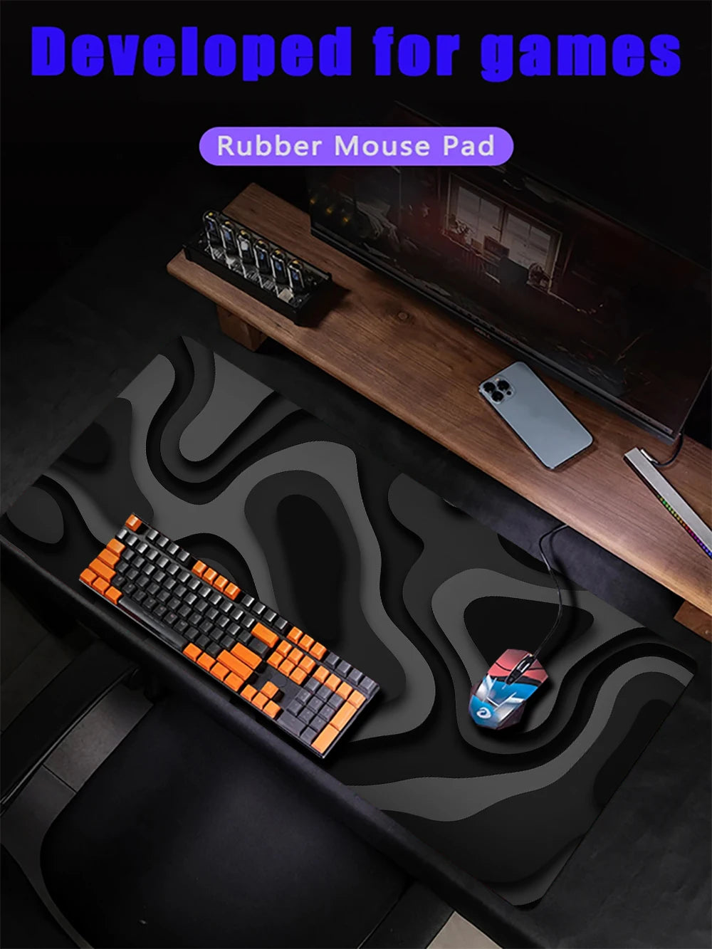 A black desk mat featuring an abstract, wavy pattern, with a mechanical keyboard and gaming mouse visible on the surface.