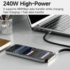 A silver 2-in-1 fast charging data cable with a phone stand is shown next to a laptop.