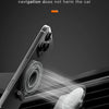 A phone is mounted on a magnetic car mount, showing strong magnetic adsorption for navigation.