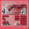 A close-up view of a mechanical keyboard featuring Raven and Sakura themed keycaps in various colors and layouts.