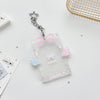 Clear acrylic card holder with a pink ribbon charm attached to a silver keychain.