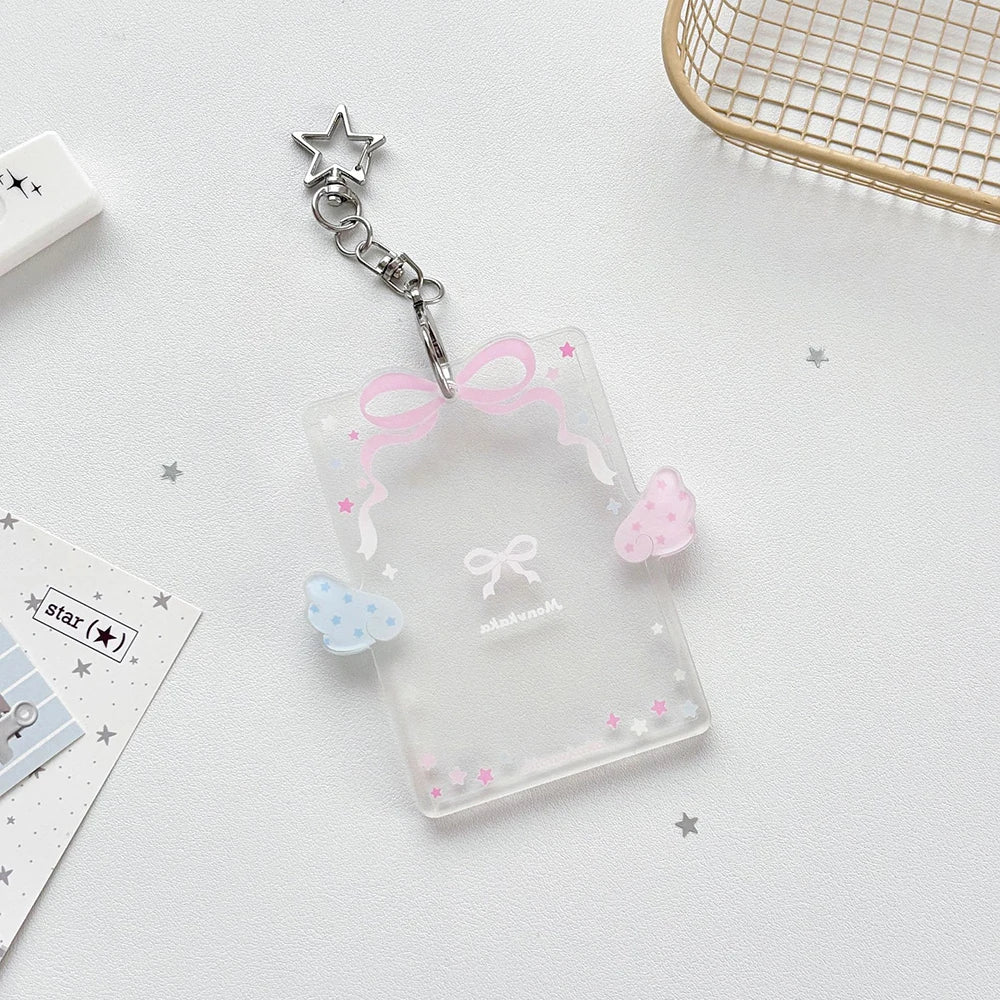Clear acrylic card holder with a pink ribbon charm attached to a silver keychain.