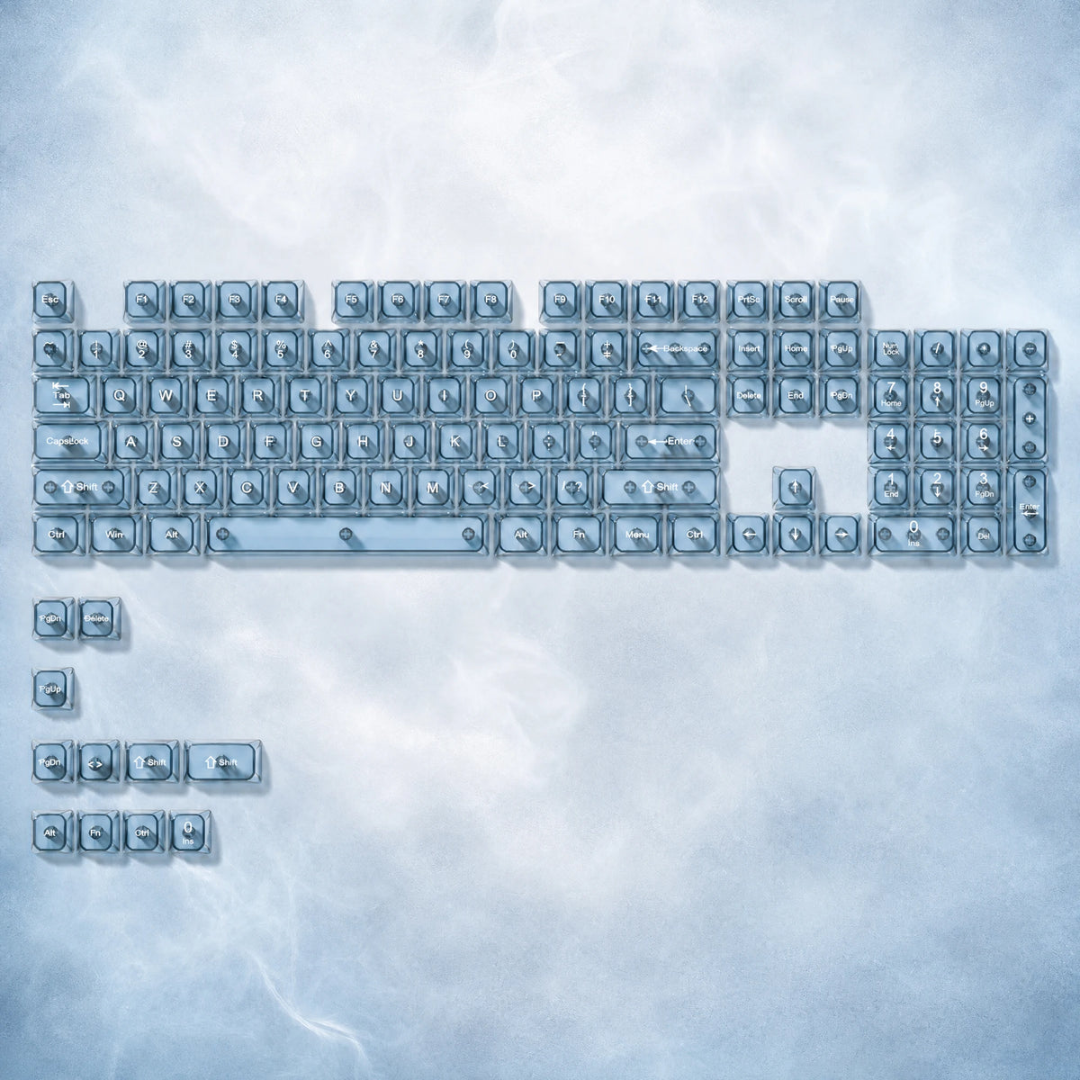 A collection of crystal clear RGB keycaps for mechanical keyboards arranged in various layouts.