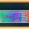 A full set of colorful rainbow shine PC keycaps for a mechanical keyboard displayed on a dark surface.