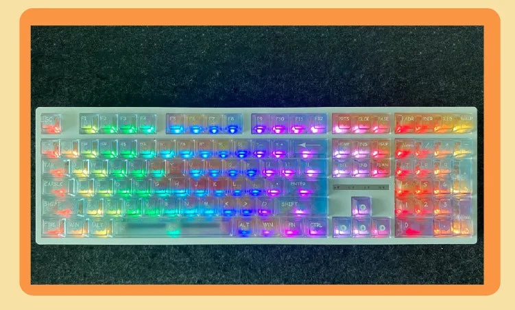 A full set of colorful rainbow shine PC keycaps for a mechanical keyboard displayed on a dark surface.