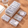 A white plastic organizer box filled with coiled white cables and connectors for desk or travel storage.
