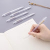 A hand holds a clear plastic mechanical pencil set with multiple pencils on a lined notebook page.