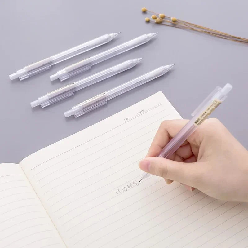 A hand holds a clear plastic mechanical pencil set with multiple pencils on a lined notebook page.