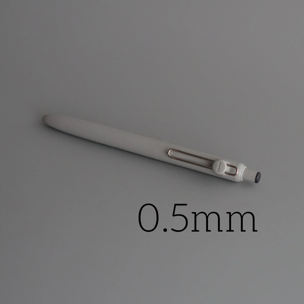 A close-up view of a silver precision gel pen with a 0.5mm tip.