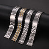 Five stainless steel watch bands with gold accents displayed on a dark surface.