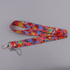 A colorful, heart-shaped lanyard with an orange and pink floral pattern, featuring a metal clip for badges or keys.