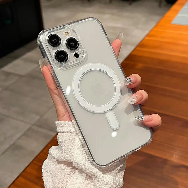 A hand holds a clear magnetic phone case with built-in magsafe compatibility against a wooden surface.