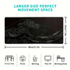 Black mouse pad featuring a large wave design and various desk items for gaming and writing