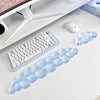 A light blue ergonomic cloud wrist rest designed for supporting the keyboard and mouse.