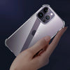 A hand holds a clear shockproof phone case for an iPhone, showing the back and camera module.